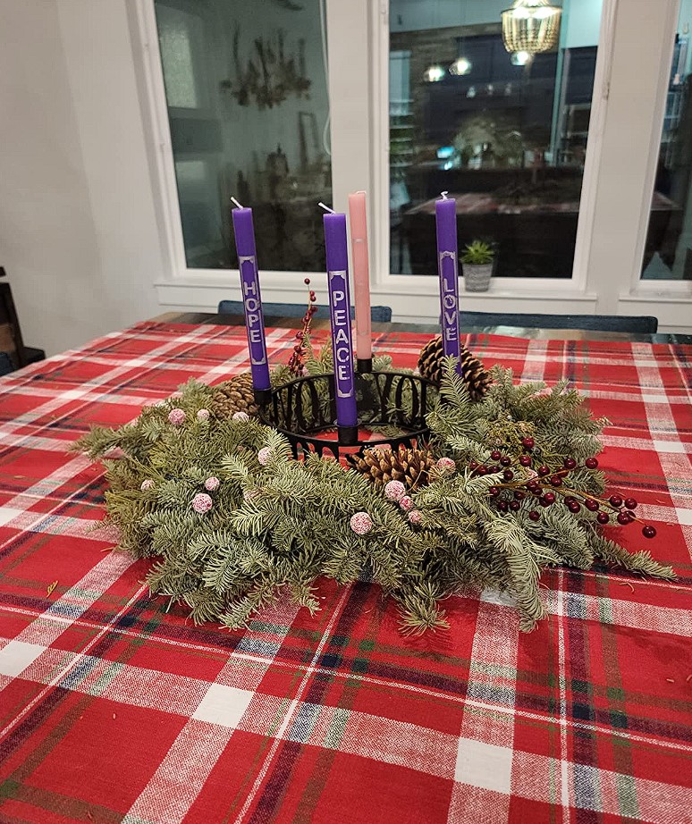 advent candle holders metal with wreath on table
