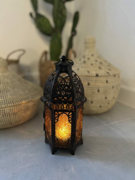 black lamp metal vintage warm LEDcandle closeup blurry background cactus gothic candle holders