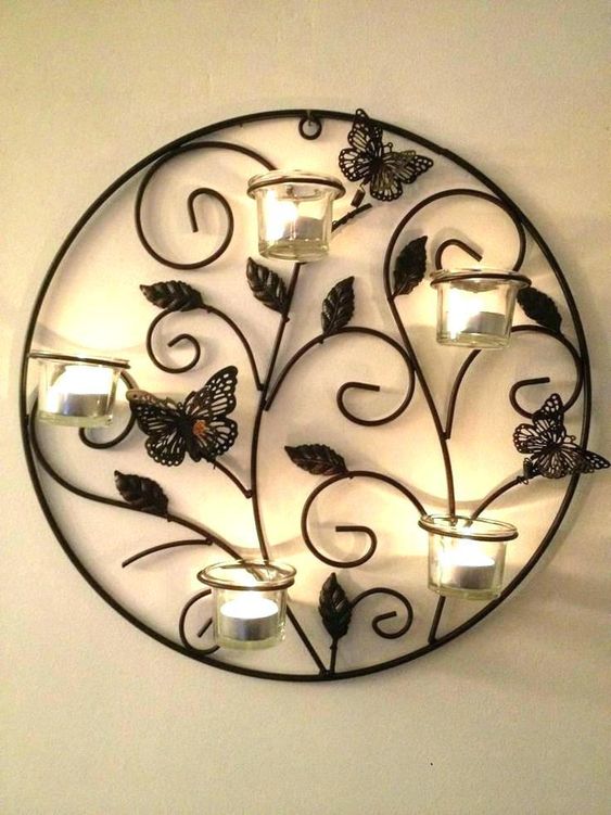 butterfly onround metal frame with intricate vine design and four votive candle holder