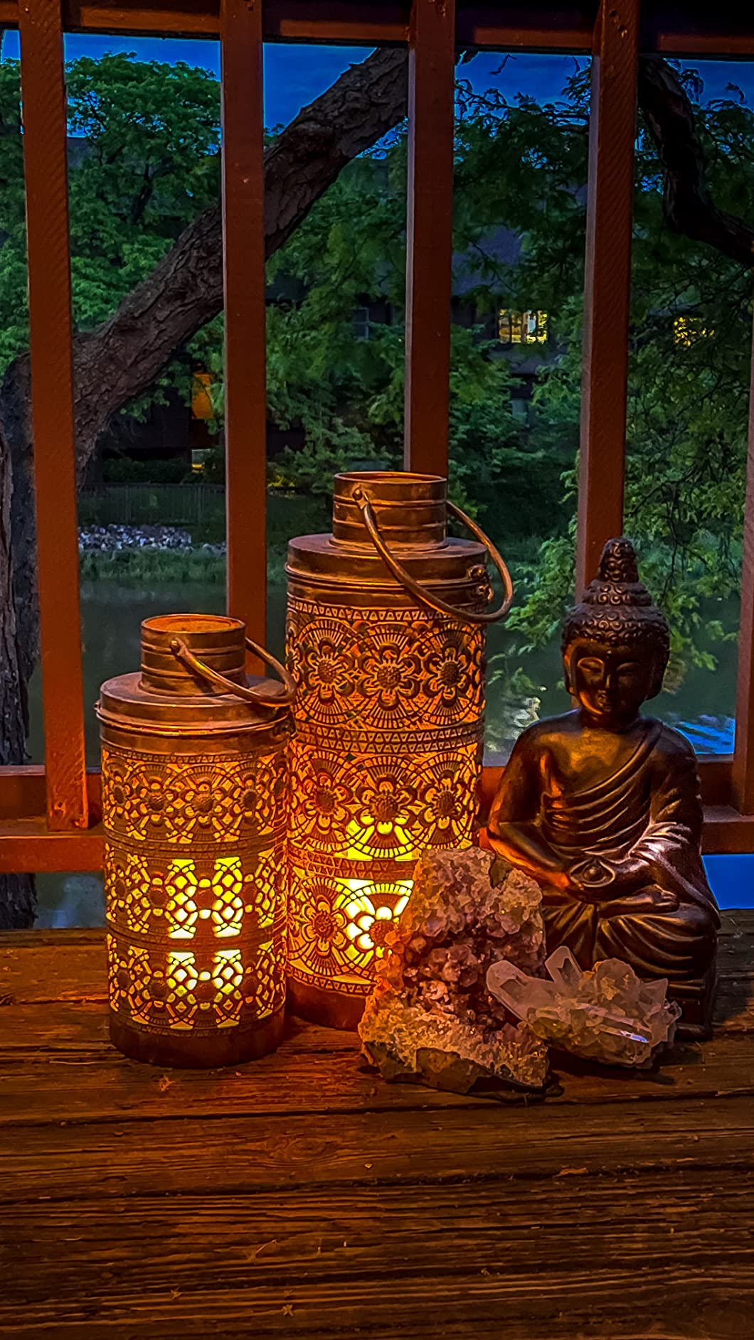 gold lamp metal closeup buddha lake background floor candle holders