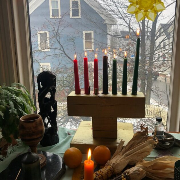 brown wooden window oranges corn kwanzaa candle holders