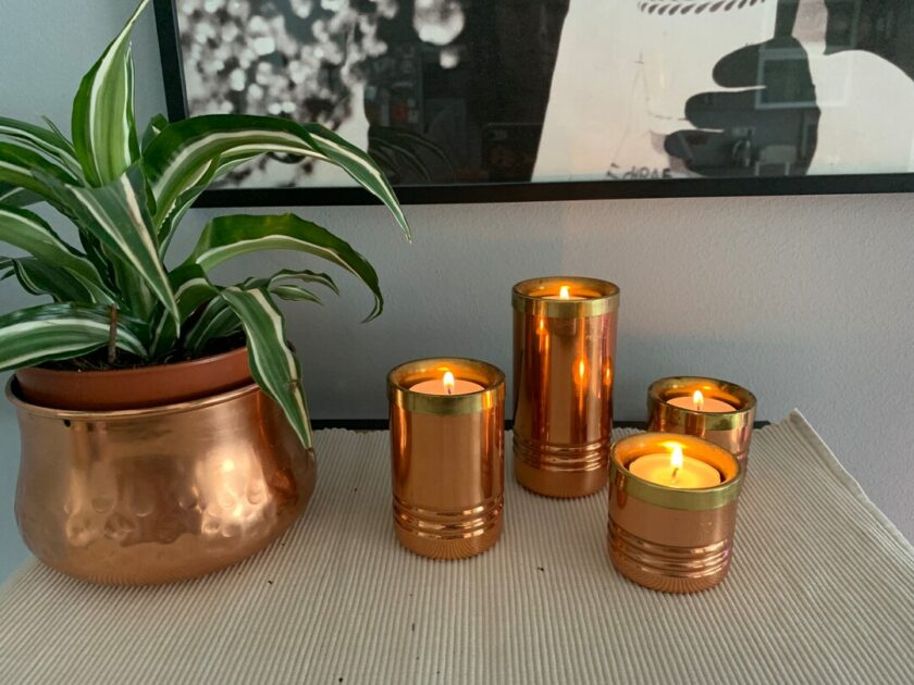 copper and brass large candle holders on table top