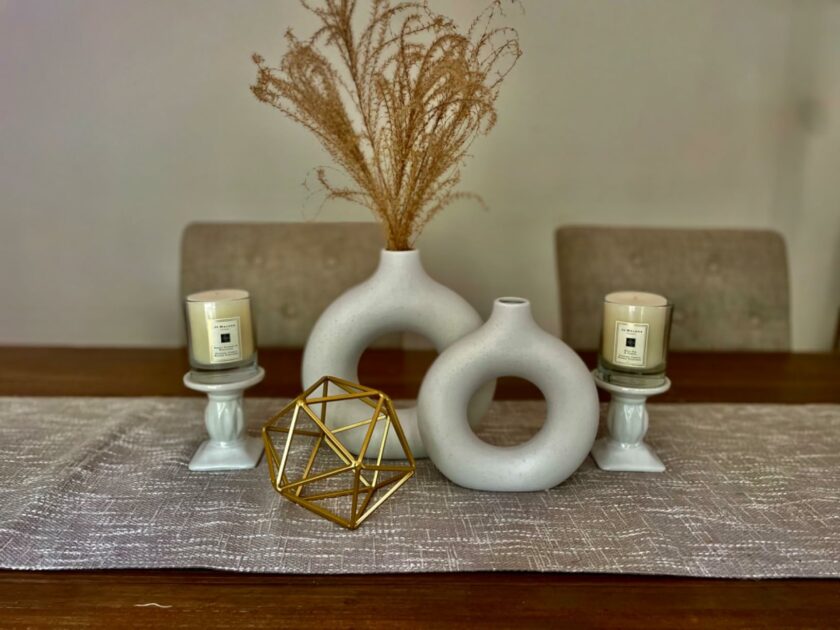 grey tablerunner jute white round vase gold geometric closeup wooden table angle view dining tables