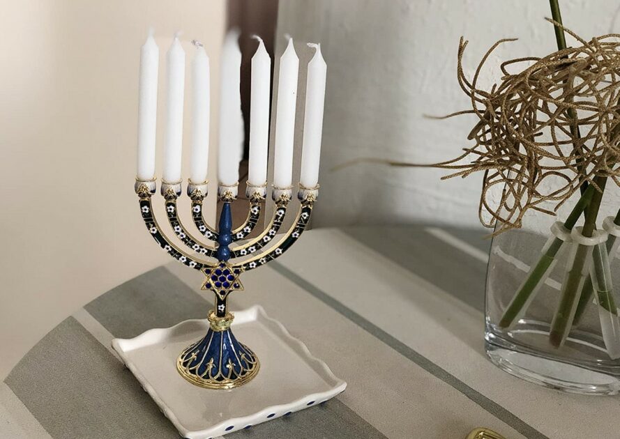 hanukkah candle holders mini bejeweled blue and gold painted on table with candles