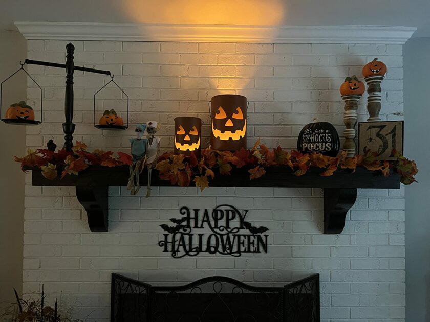 orange bucket metal leaves garland white brick fireplace healthcare skeletons pumpkin candle holders