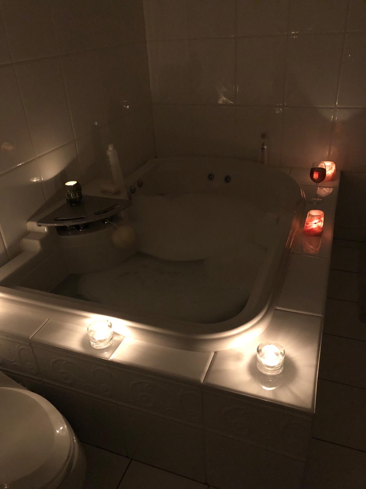 clear tealightcandles glass crystal bathtub bubbles white0tiles top angle view candle holders in the bathroom
