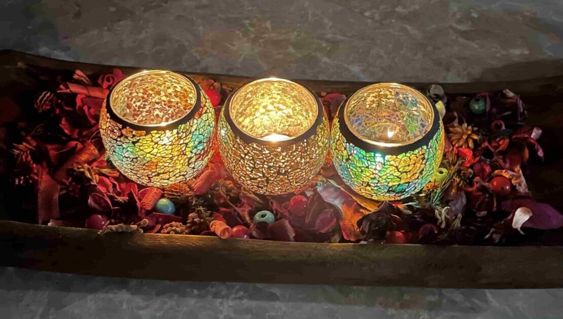 colorful glasspane dried flower petals closeup top view candle holders in the bathroom