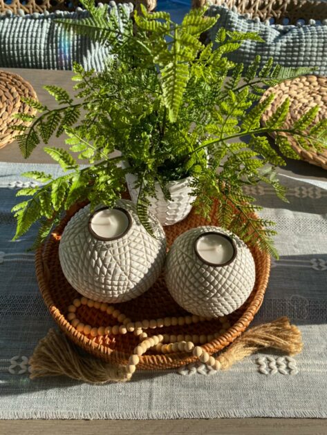 white pattern rattan tray wooden beads garland grey tablerunner closeup top view exotic candle holders