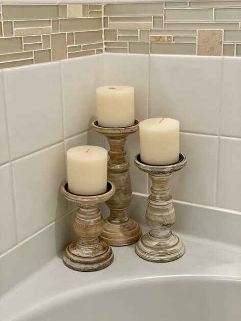 whitewashed pillarcandles wooden corner tub angle view closeup candle holders in the bathroom