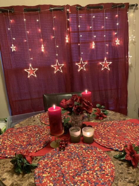 yellow stringlight stars red curtain candle round table christmas lights decor
